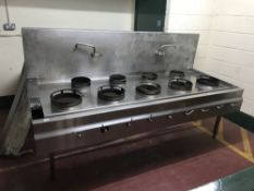 A large stainless steel nine ring commercial cooking range