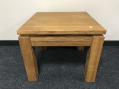 A contemporary oak lamp table