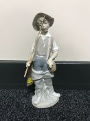A Lladro figure - boy with fishing rod