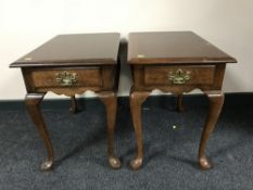 A pair of contemporary walnut end tables fitted with drawers