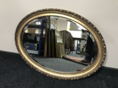 An oval gilt framed bevel edged mirror