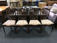 A set of four mahogany shield backed dining chairs