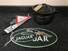 A cast iron three leg pot with lid,