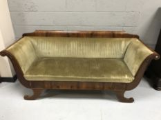 An early 20th century walnut framed scroll arm settee