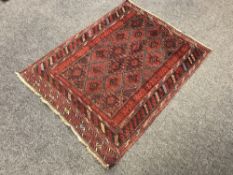 A Balouchi rug on red ground
