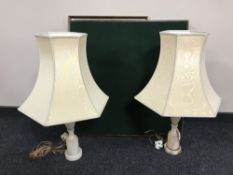 A pair of marble table lamps with shades together with a teak mirror and a folding table