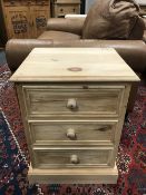 A pine three drawer bedside chest,