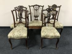 A late Victorian Hepplewhite style carver armchair on claw and ball feet and four dining chairs