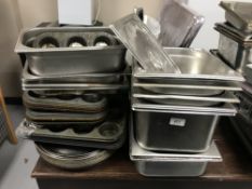 A large quantity of bain marie dishes, kitchen utensils, pudding trays,