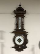 A heavily carved barometer