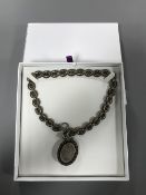 An antique silver Victorian locket and chain