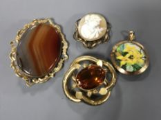 Four pieces of antique jewellery including a gold locket