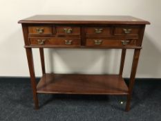 An inlaid side table on reeded legs fitted six drawers