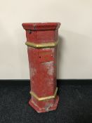 A painted cast metal cigarette bin