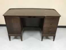 A mid 20th century teak twin pedestal desk