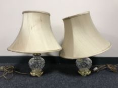 A pair of cut glass table lamps on brass bases with shades