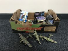 A box containing die cast aeroplanes,