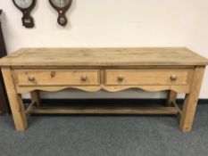 An antique style pine sideboatrd fitted with two drawers,