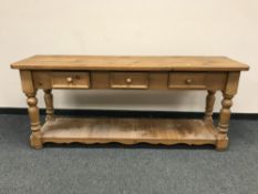 A Victorian style pine dresser fitted with three drawers,