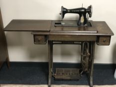A vintage Singer treadle sewing machine in oak table