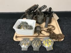 A tray of vintage blow torches, balance scales,