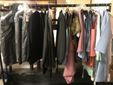 A rail of mid 20th century and later lady's clothing