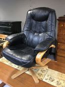 A beech framed black leather swivel armchair
