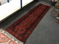 A fringed Persian Shiraz runner on red ground