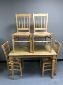 A pine effect kitchen table and four rush seated chairs