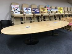An oval beech boardroom table,