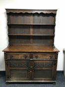A carved oak double door dresser