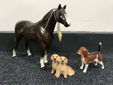 A brown gloss china horse together with two Beswick dog ornaments;