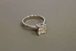 A heavy platinum ring set with four princess cut diamonds, approximately 1.0 carat total weight, 6.
