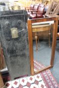 A rosewood framed mirror and a folding metal fire screen