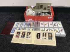 A box of cigarette cards in albums,