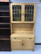 A blonde oak leaded glass door cabinet fitted cupboards and shelf below