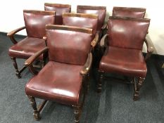 A set of seven armchairs upholstered in Burgundy buttoned leather