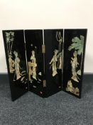 A contemporary black lacquered four way folding table screen