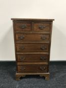 A reproduction mahogany six drawer chest