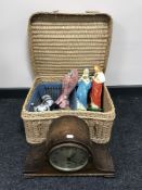 An oak mantel clock, picnic basket containing tea service, religious figures,