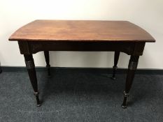 An early 20th century inlaid mahogany table on reeded legs