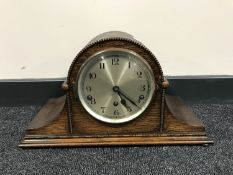 An oak mantel clock with silvered dial