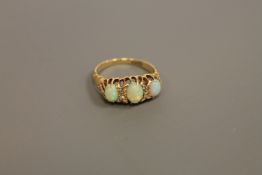 A three stone opal and diamond set ring CONDITION REPORT: Good condition.
