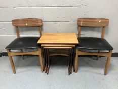 A nest of three teak G-Plan tables together with a pair of late 20th century teak dining chairs