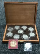 A coin box containing nine commemorative crowns and two other coins