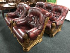 A wood framed button leather three piece lounge suite