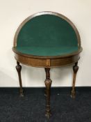 An oak turnover topped card table on carved legs CONDITION REPORT: Split to the