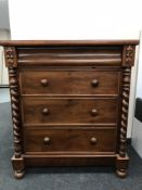 A Victorian mahogany three drawer chest with twist column supports