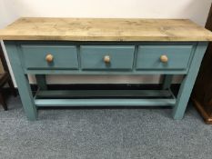 A painted pine low dresser fitted with three drawers