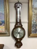 A Victorian inlaid rosewood barometer with silvered dial